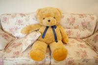 a brown teddy bear sitting on a couch at Blue Cotton Candy B&amp;B in Taitung City