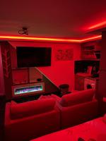 a red living room with a couch and a fire place at Sweet home in Bagnolet