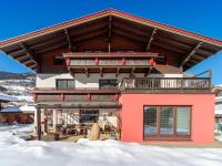 a house in the snow with a large roof at Apartment in Bramberg am Wildkogel with balcony in Bramberg am Wildkogel