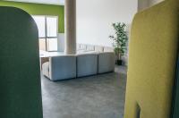 a living room with a couch and a table at Twenty Business Flats Béziers in Béziers