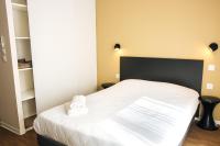 a bedroom with a bed with white sheets and towels at Twenty Business Flats Béziers in Béziers