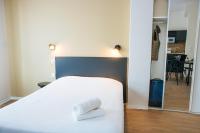 a bedroom with a bed with two towels on it at Twenty Business Flats Béziers in Béziers