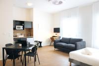 a living room with a couch and a table at Twenty Business Flats Béziers in Béziers