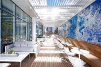 a lobby with tables and couches in a building at HALL Arts Hotel Dallas, Curio Collection by Hilton in Dallas