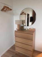 a room with a dresser with a mirror on the wall at Le Petit Port in Sedan
