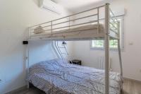 a bedroom with a bunk bed in a room at Maison des Charmettes in Nîmes