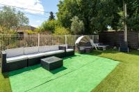 a garden with a couch and a table and a grill at Maison des Charmettes in Nîmes