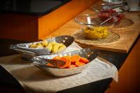 two bowls of fruit on a counter with other bowls of food at Gyeongju Mauna Ocean Resort in Gyeongju