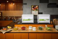 two microwaves on a counter in a kitchen with food at Gyeongju Mauna Ocean Resort in Gyeongju