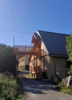 a house with a deck on the side of it at Chez Pierrette et Eugène Prix nuitée&#47;10 personne in Le Lautaret