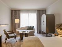 a hotel room with a bed and a couch and a table at The Playford Adelaide - MGallery in Adelaide