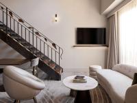 a living room with a couch and a table at The Playford Adelaide - MGallery in Adelaide