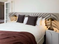 a bedroom with a large white bed with pillows at The Playford Adelaide - MGallery in Adelaide