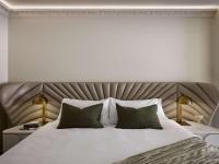 a bedroom with a large bed with two tables and two lamps at The Playford Adelaide - MGallery in Adelaide