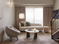 a living room with a couch and a table at The Playford Adelaide - MGallery in Adelaide