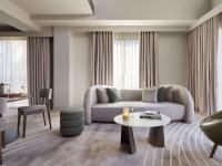 a living room with a couch and a table at The Playford Adelaide - MGallery in Adelaide