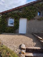 a white door in the side of a building at Maison au calme avec vue étang in Clessé