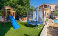 a playground with a blue slide in a yard at Stunning Home In Vinjani Donji With 5 Bedrooms, Wifi And Outdoor Swimming Pool in Majići