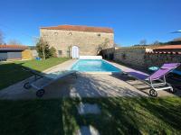 a villa with a swimming pool and two chairs at Au pool house de la Faye avec jacuzzi in Saint-Romain-Lachalm