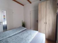 a bedroom with a bed and a wooden cabinet at Gästehaus im Alten Fährhaus in Cochem