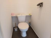 a bathroom with a white toilet in a stall at résidence la clairière aux portes de la baie de Somme in Abbeville