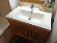 a bathroom with a white sink and a tub at résidence la clairière aux portes de la baie de Somme in Abbeville