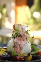 a close up of a sandwich with vegetables on a plate at Surga Alaçatı in Cesme