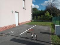 a parking lot with a bike rack in front of a building at résidence la clairière aux portes de la baie de Somme in Abbeville