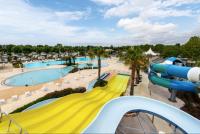 a slide at a water park with a pool at Bungalow de 3 chambres avec piscine partagee et terrasse a Vias a 1 km de la plage in Vias