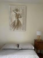 a bedroom with a painting on the wall and a bed at Un moment de Détente au cœur de Vals-les-Bains in Vals-les-Bains