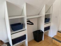 a white closet with shelves and a basket at Bel appartement hyper centre in Bernay