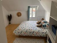 a bedroom with a bed with pillows on it at Bel appartement hyper centre in Bernay