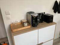 a counter with a coffee maker and a toaster on it at Bel appartement hyper centre in Bernay