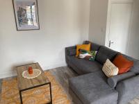 a living room with a couch and a coffee table at Bel appartement hyper centre in Bernay