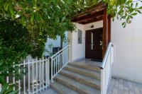 a staircase leading up to a house with a wooden door at apartmani stefan in Orebić