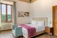 A bed or beds in a room at Palazzo Catalani Resort
