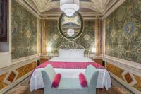 A bed or beds in a room at Palazzo Catalani Resort