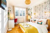 a bedroom with a bed with a yellow blanket at Double Appartements 2&amp;3 210 sqm up to 18 guests, Villa des Ammonites in Meudon
