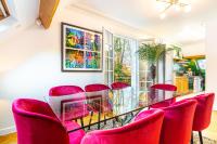 a dining room with red chairs and a glass table at Double Appartements 2&amp;3 210 sqm up to 18 guests, Villa des Ammonites in Meudon