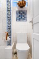 a bathroom with a toilet and blue and white tiles at Double Appartements 2&amp;3 210 sqm up to 18 guests, Villa des Ammonites in Meudon