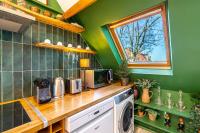 a kitchen with green walls and a counter with a microwave at Double Appartements 2&amp;3 210 sqm up to 18 guests, Villa des Ammonites in Meudon