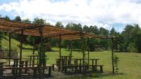a group of wooden picnic tables in a field at Agricampeggio Madonna di Pogi in Bucine