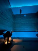 a dark room with a table and a blue light at Zen Room in LʼIsle-sur-le-Doubs