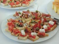 a plate of food with sandwiches on a table at Hotel Villa Breg in Vršac