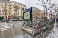 a bus stop with a bike parked next to a street at Sweet Inn - Chevalier Saint Georges in Paris