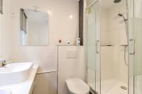 a bathroom with a sink and a toilet and a shower at Sweet Inn - Chevalier Saint Georges in Paris