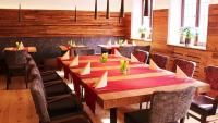 a large wooden table in a restaurant with chairs at Hotel Gasthof Adler in Ulm