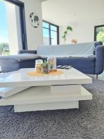 a living room with a blue couch and a white coffee table at Maison de vacances à Loctudy in Loctudy