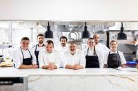 a group of chefs standing in a kitchen at La Bastide Bourrelly - Mathias Dandine in Cabriès