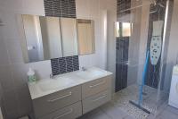 a bathroom with a sink and a shower at Charmante petite maison in Torcenay